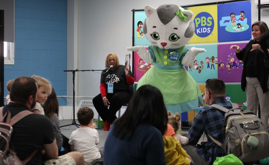 Katerina Kittycat joins Mrs. Robin Pizzo for storytime at Be My Neighbor Day at Impression 5 Science Center with WKAR. Supported by PNC Grow Up Great. (Bailey Maloney / WKAR-MSU)